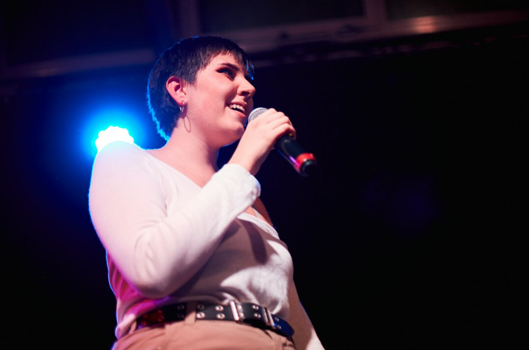 leader on stage with microphone